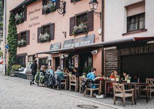 luxemburg restaurang 300x213 - Vianden, Luxembourg - May 18, 2019: People Sitting At The Outdoo